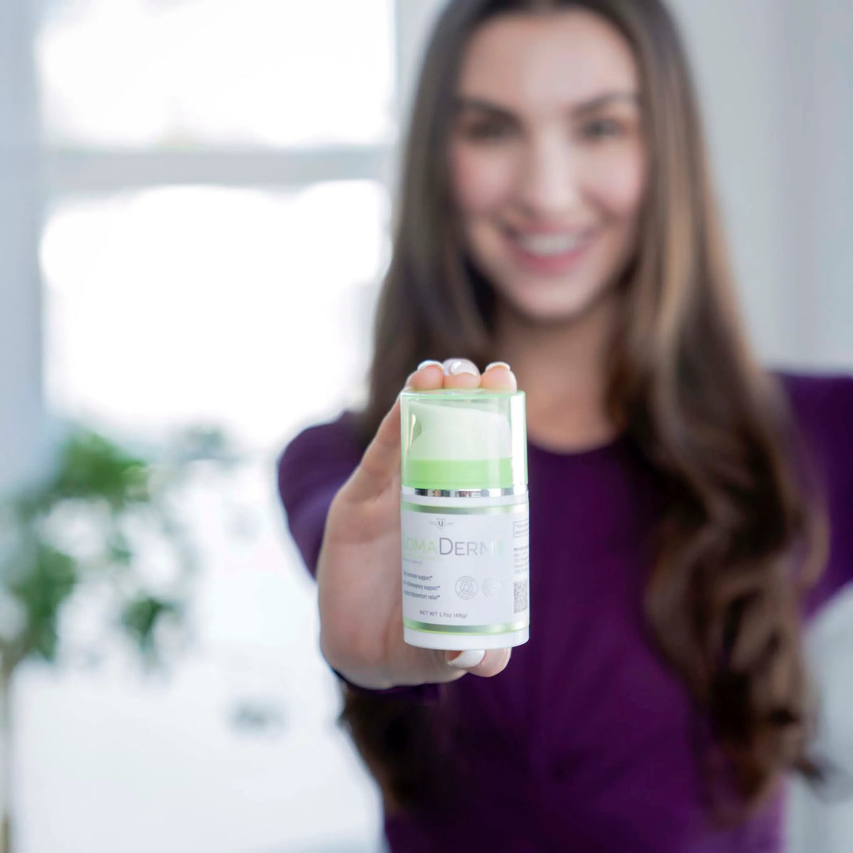Woman_holding_SomaDerm_AWE.webp